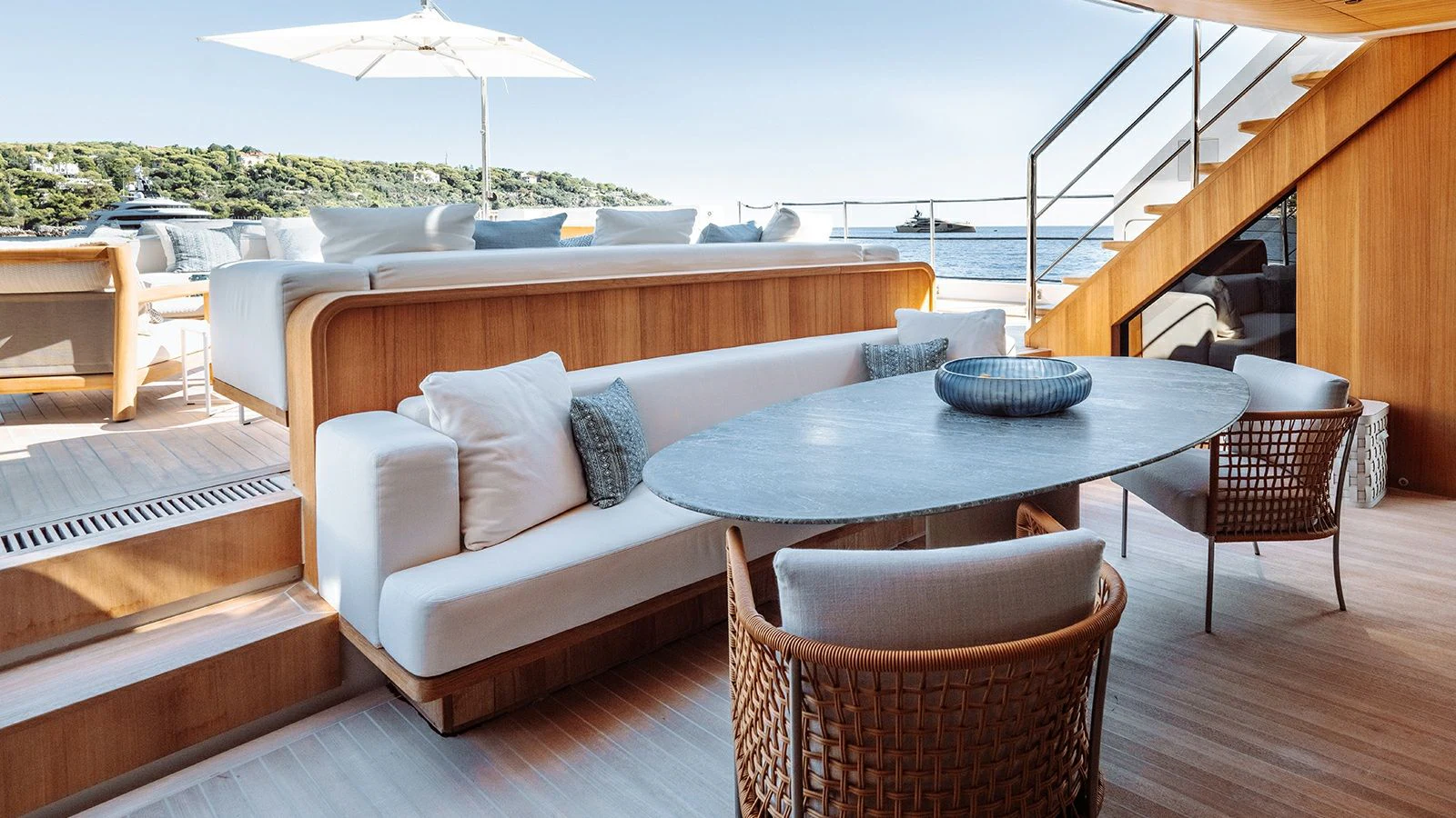 a table and chairs on a deck aboard LA LA LAND Yacht for Charter