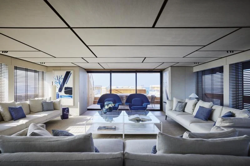 a living room with a large window aboard LA LA LAND Yacht for Charter