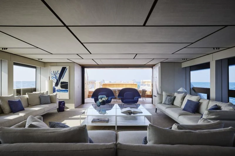 a living room with a large window aboard LA LA LAND Yacht for Charter