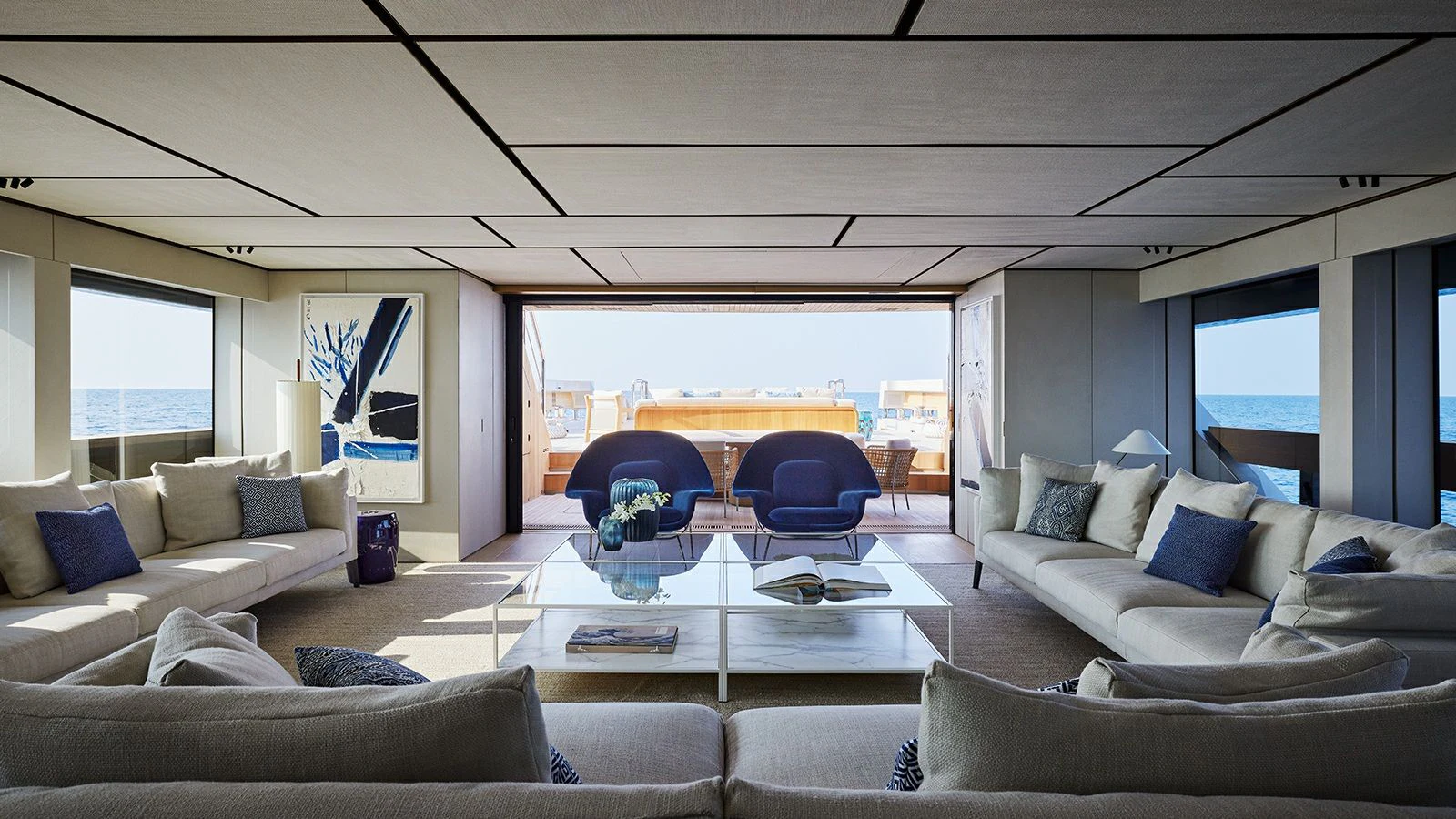 a living room with a large window aboard LA LA LAND Yacht for Charter