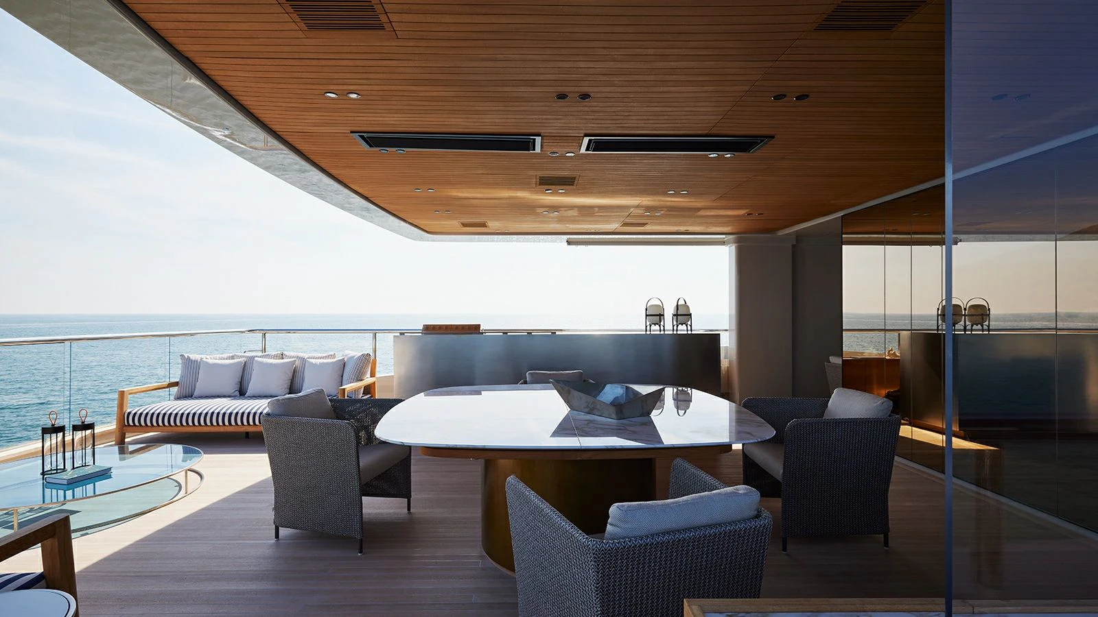 a modern living room with a large table and chairs aboard LA LA LAND Yacht for Charter