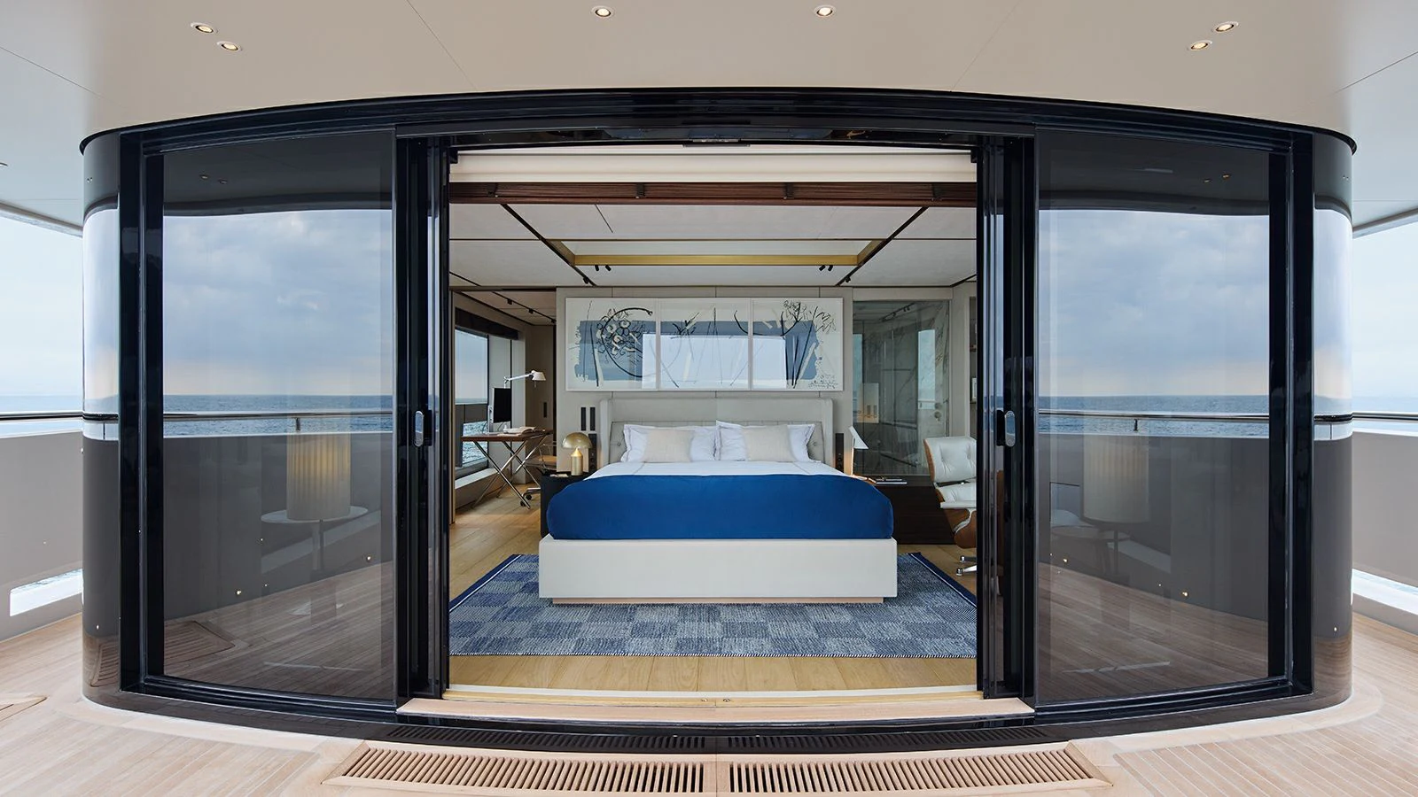 a room with a bed and a sliding glass door aboard LA LA LAND Yacht for Charter