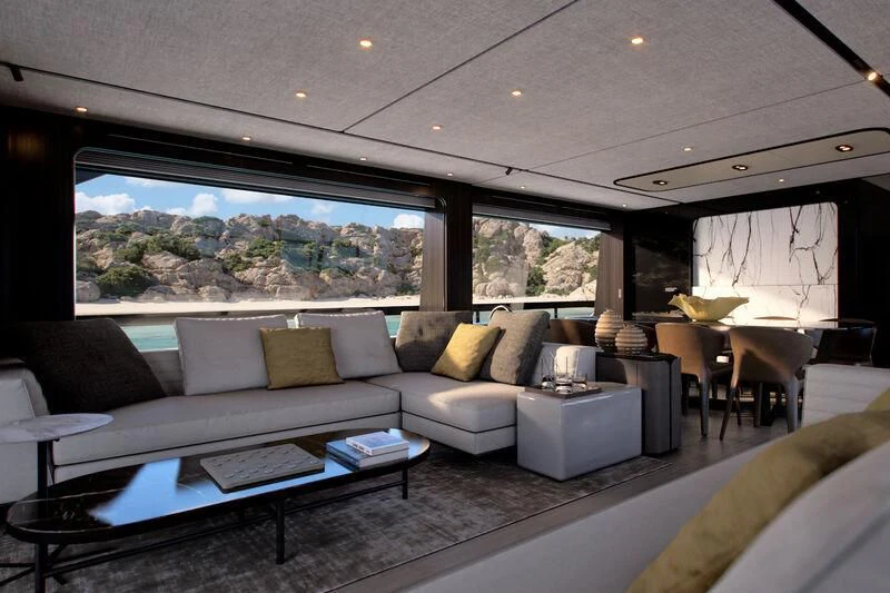 a living room with a large glass window aboard REV Yacht for Sale