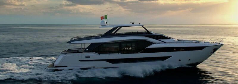 a white yacht in the ocean aboard REV Yacht for Sale