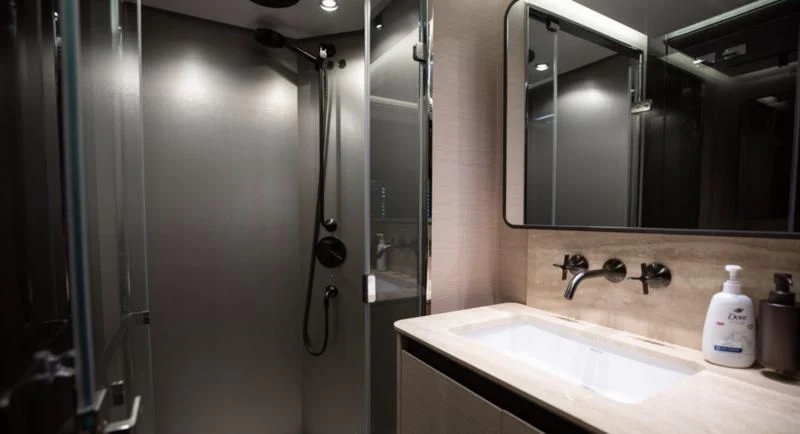 a bathroom with a shower unit and sink aboard BASH II Yacht for Sale