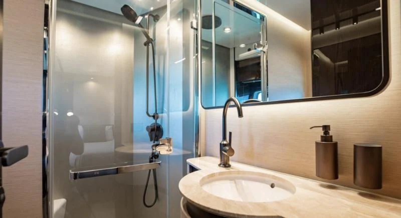 a bathroom with a sink and a mirror aboard BASH II Yacht for Sale