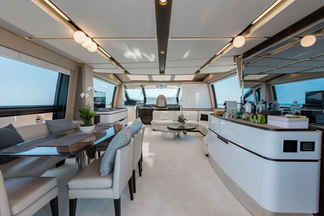 a room with a table chairs and a large window aboard BASH II Yacht for Sale
