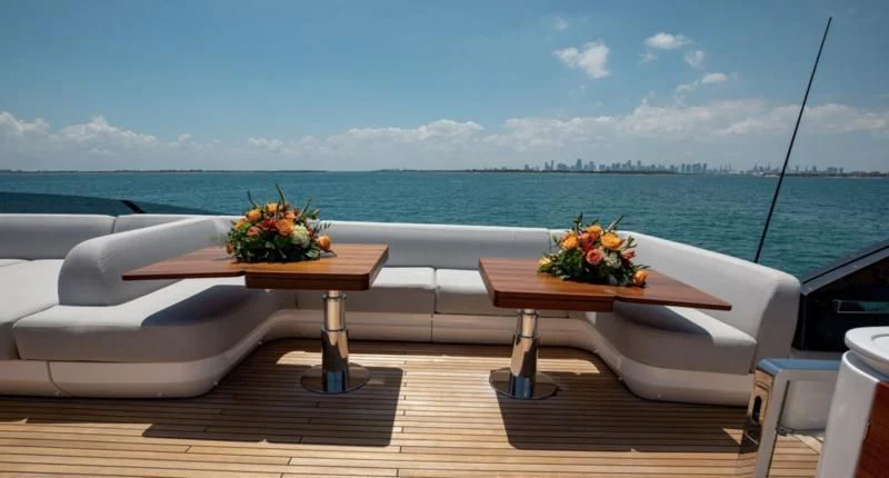 a table with flowers on it by a window overlooking a body of water aboard BASH II Yacht for Sale