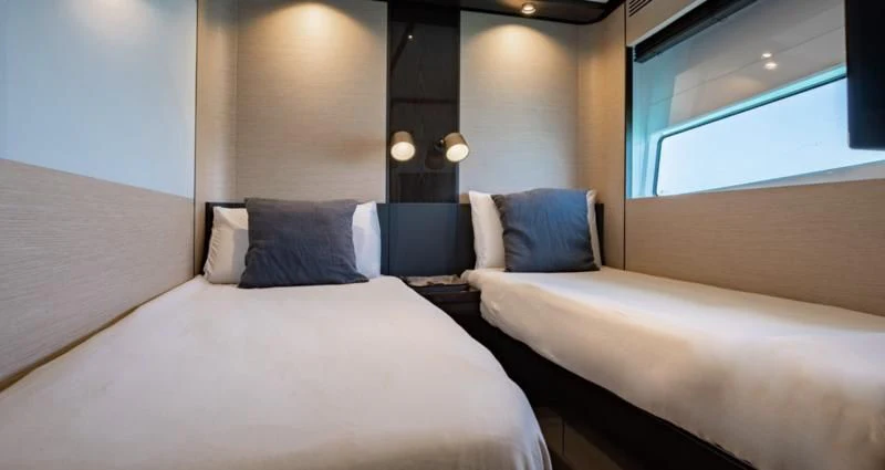 a room with two beds aboard BASH II Yacht for Sale