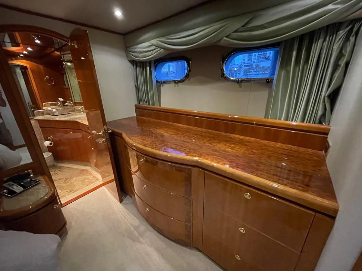 a room with a wood cabinet and a mirror aboard HAPPY Yacht for Sale