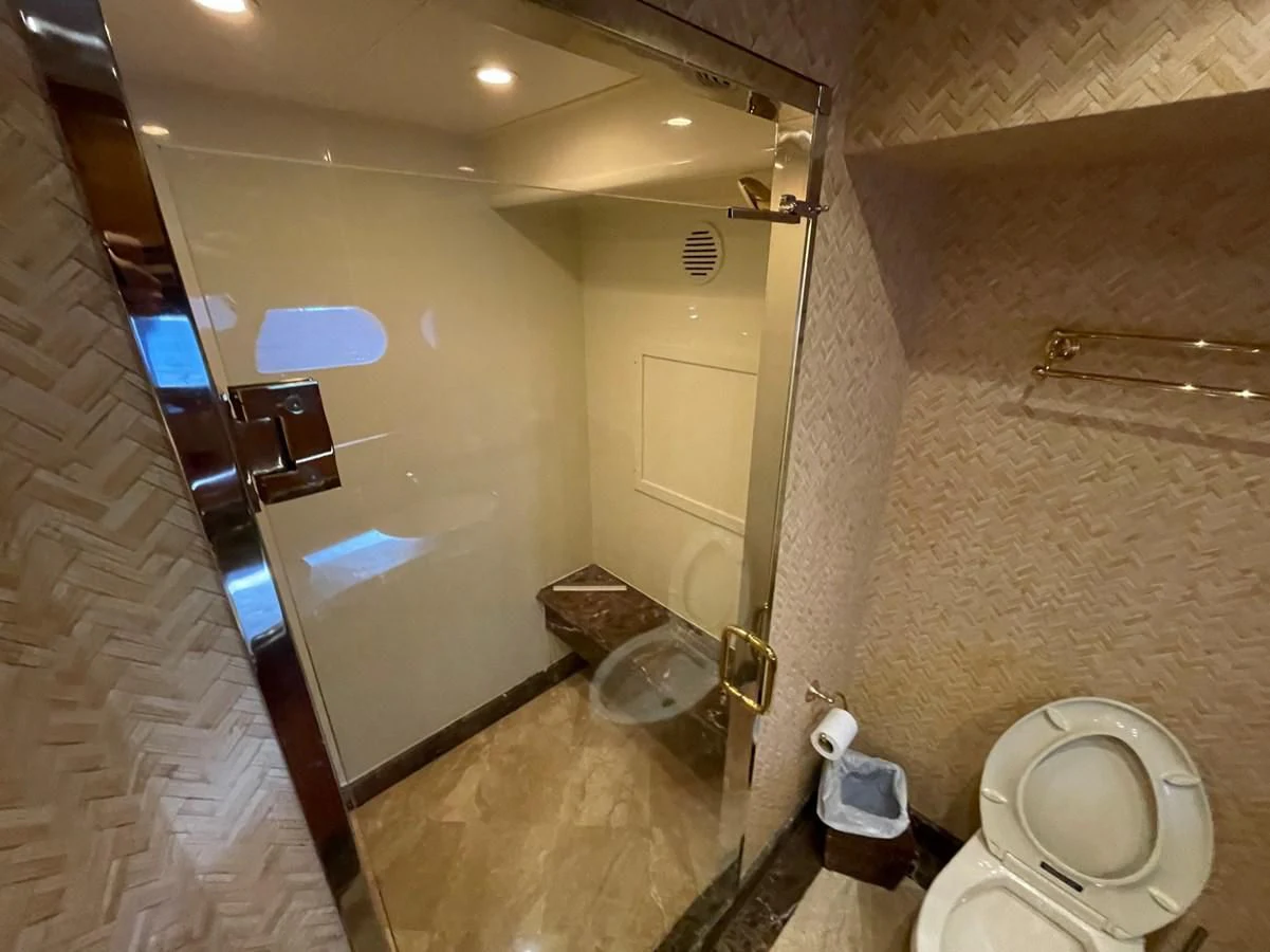 a bathroom with a large mirror aboard HAPPY Yacht for Sale