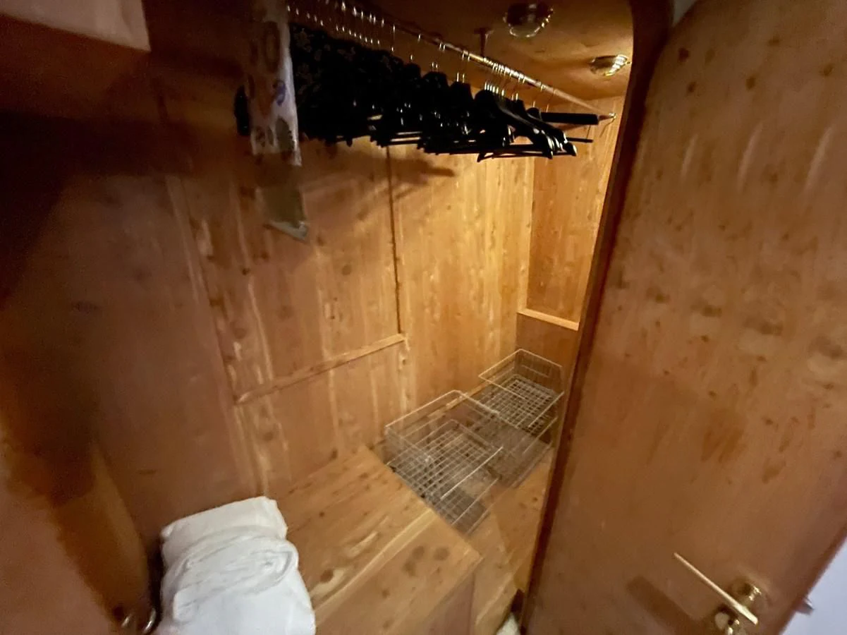 a room with a bed and a mirror aboard HAPPY Yacht for Sale