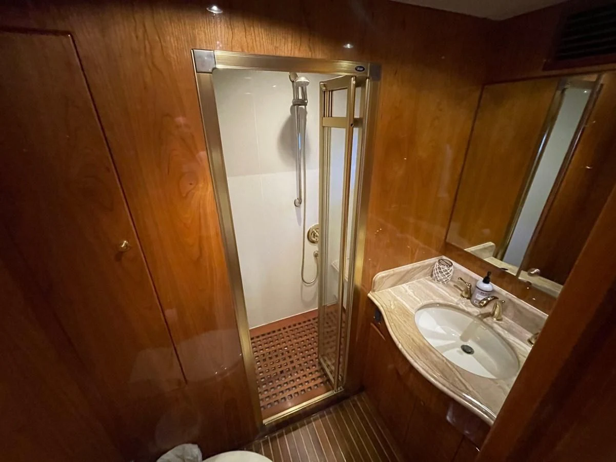 a bathroom with a shower and sink aboard HAPPY Yacht for Sale