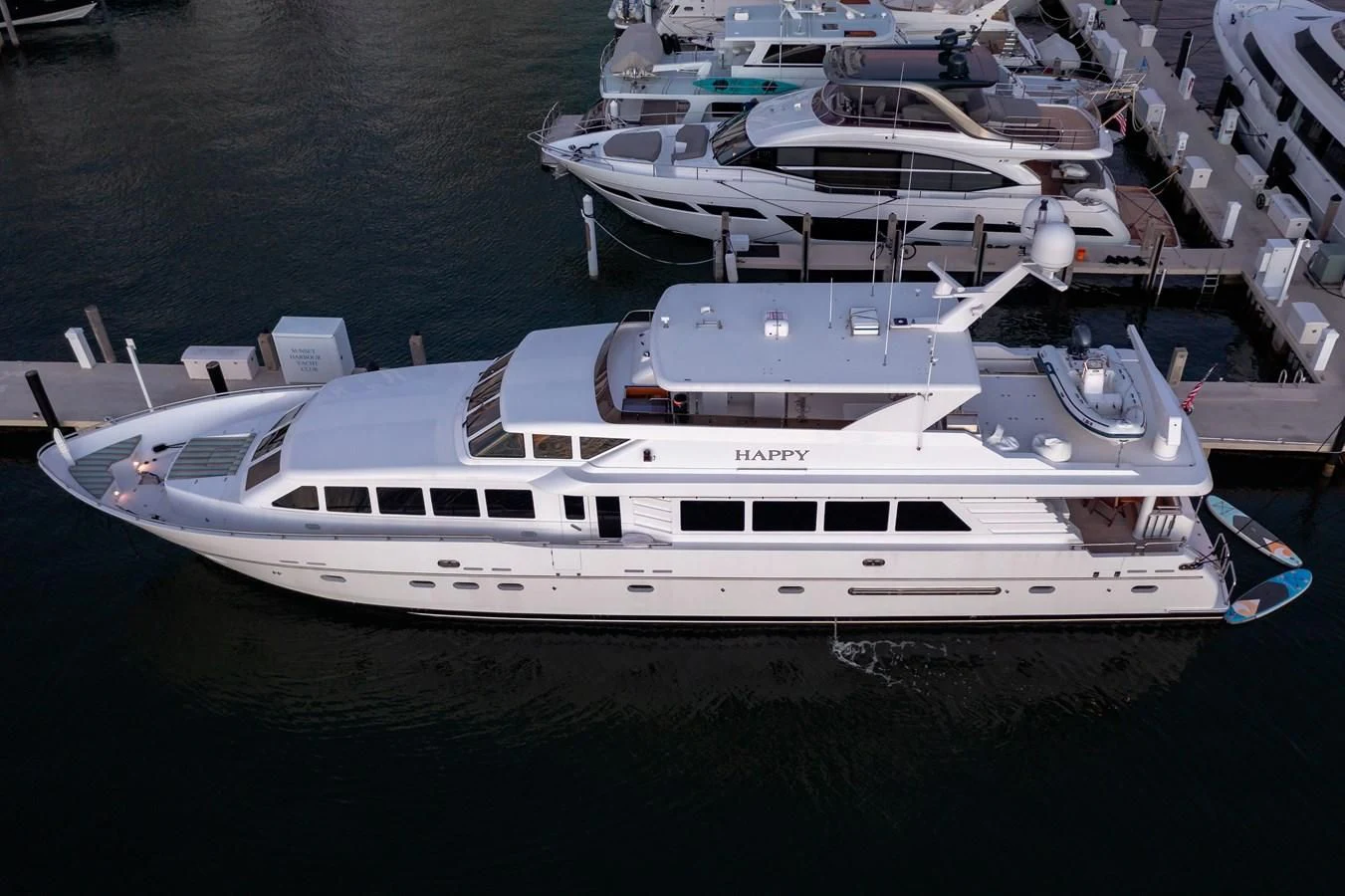 a boat docked at a pier aboard HAPPY Yacht for Sale