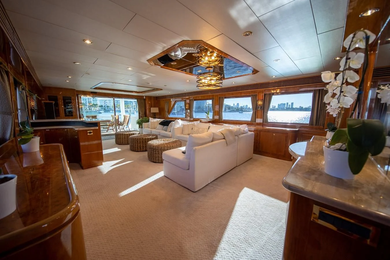 a living room with a large chandelier aboard HAPPY Yacht for Sale