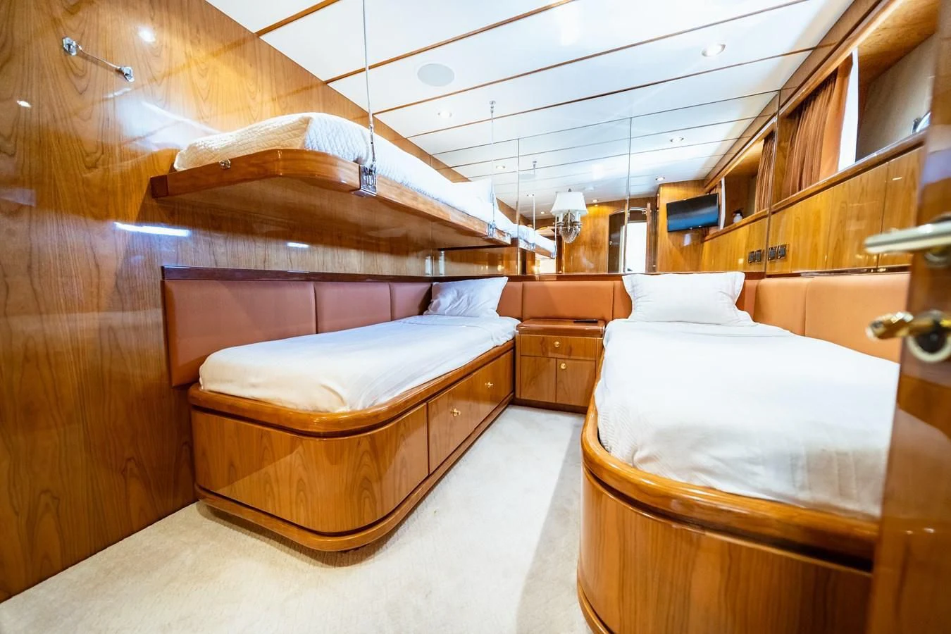 a room with a bed and a wooden wall aboard HAPPY Yacht for Sale