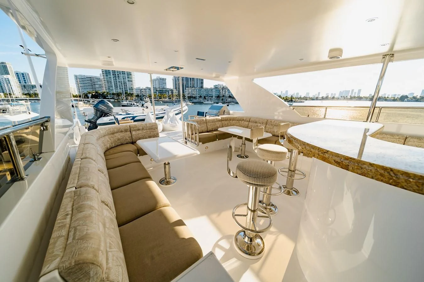 a room with a couch and a table with chairs aboard HAPPY Yacht for Sale