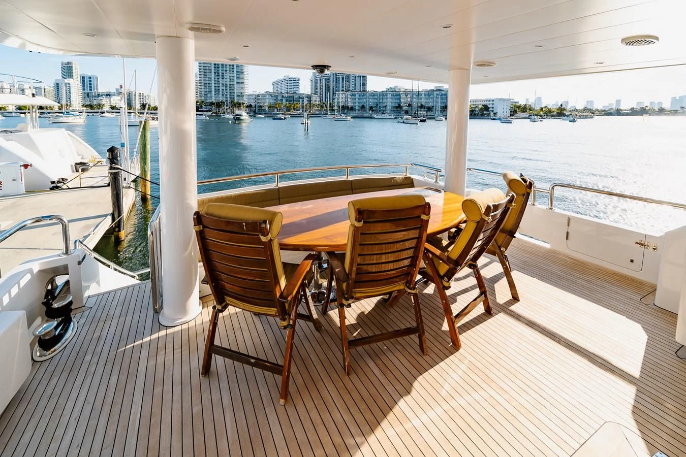 a table and chairs on a deck aboard HAPPY Yacht for Sale