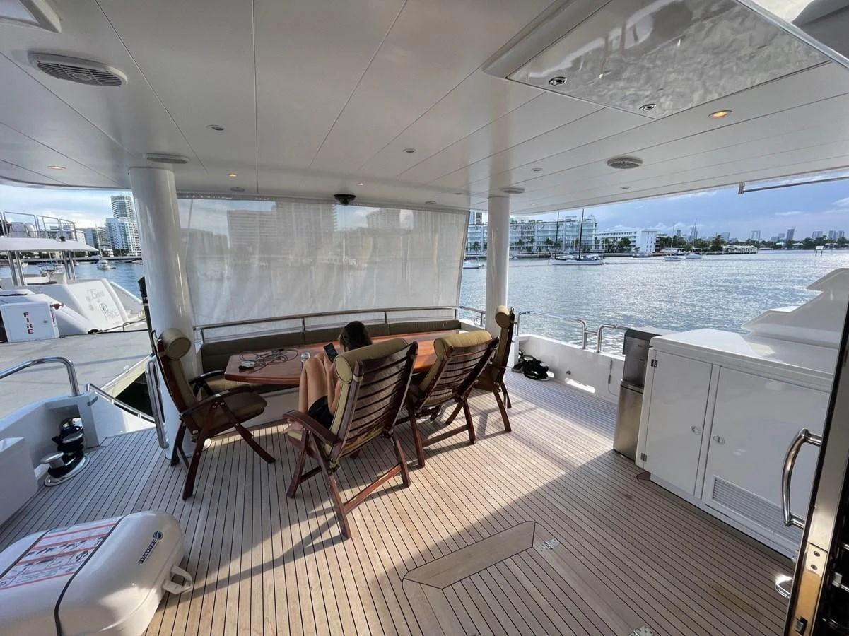 a large room with a table and chairs aboard HAPPY Yacht for Sale