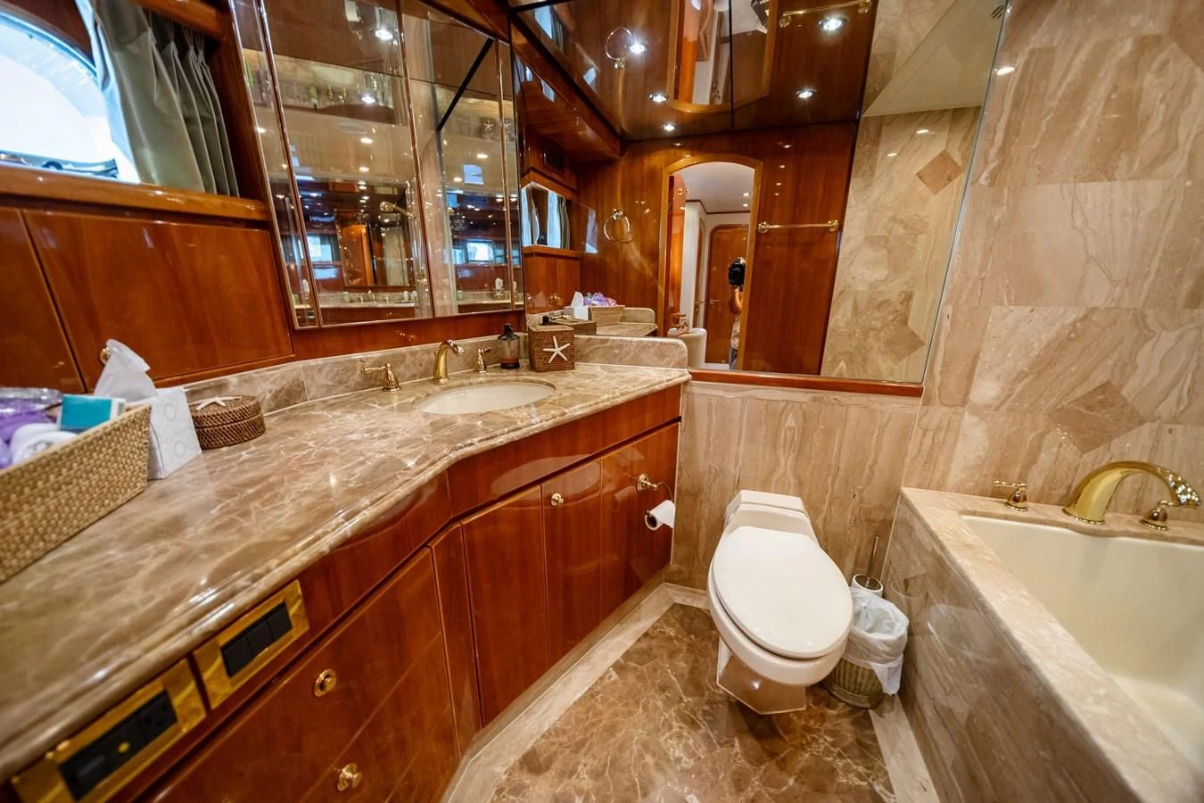 a bathroom with a tub sink and toilet aboard HAPPY Yacht for Sale