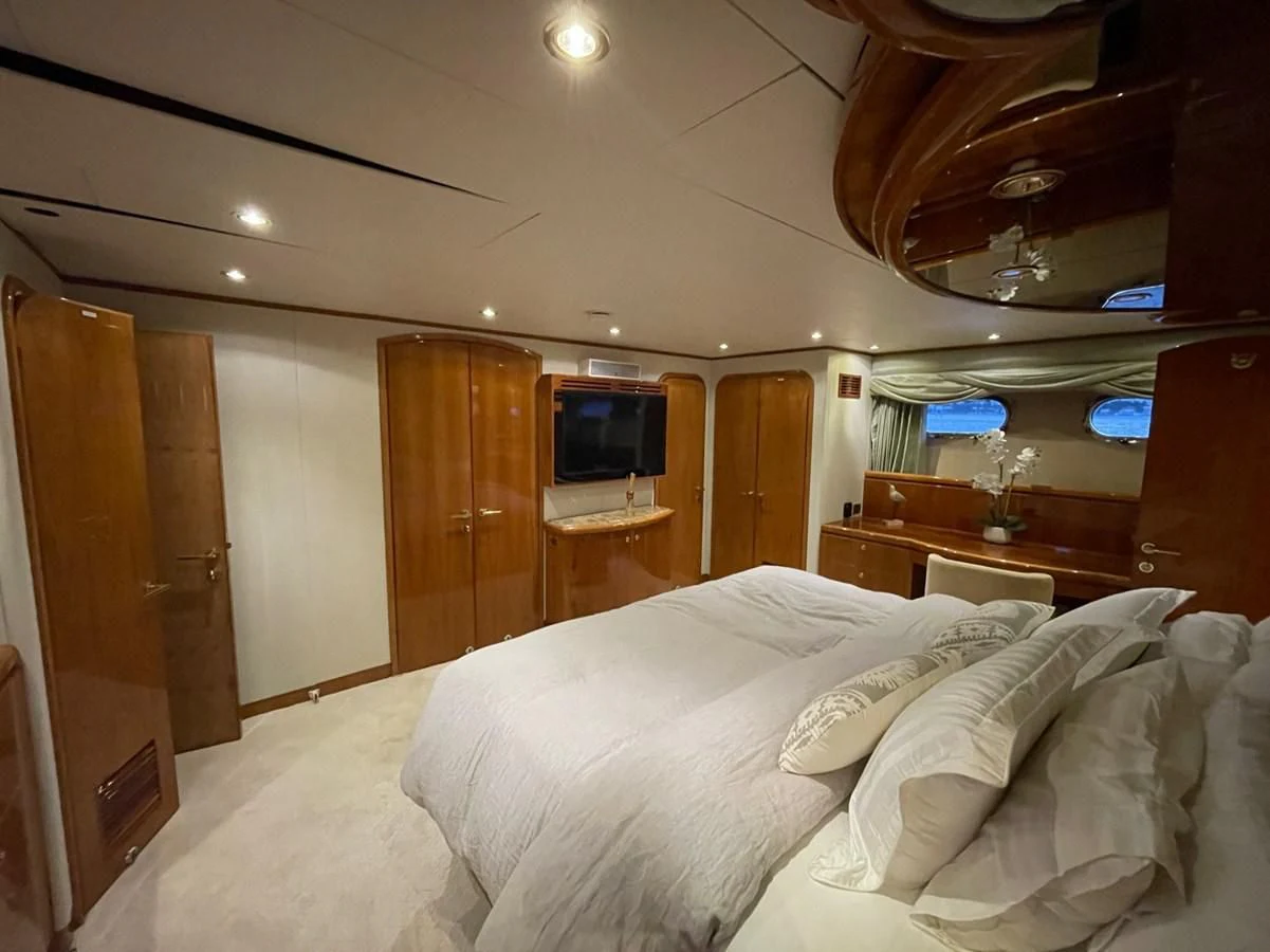 a bed with white sheets aboard HAPPY Yacht for Sale