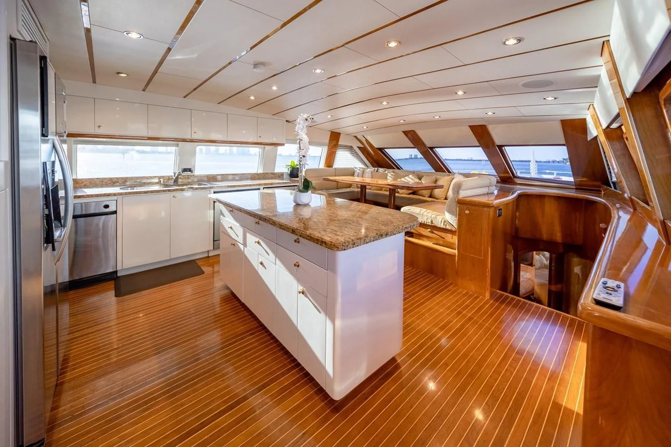 a large kitchen with wood floors aboard HAPPY Yacht for Sale