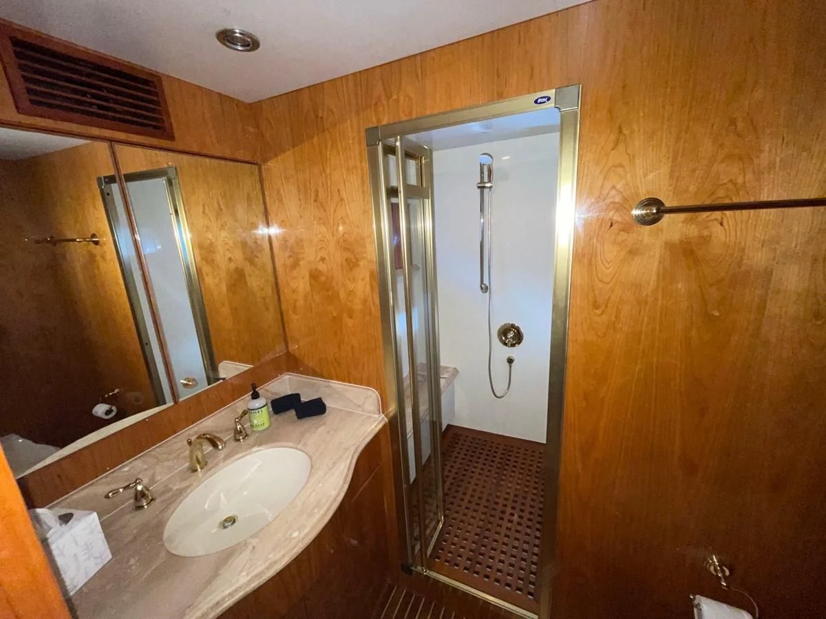 a bathroom with a sink and a mirror aboard HAPPY Yacht for Sale