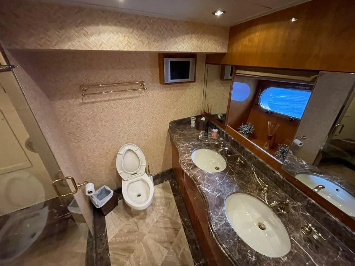 a bathroom with a large mirror aboard HAPPY Yacht for Sale
