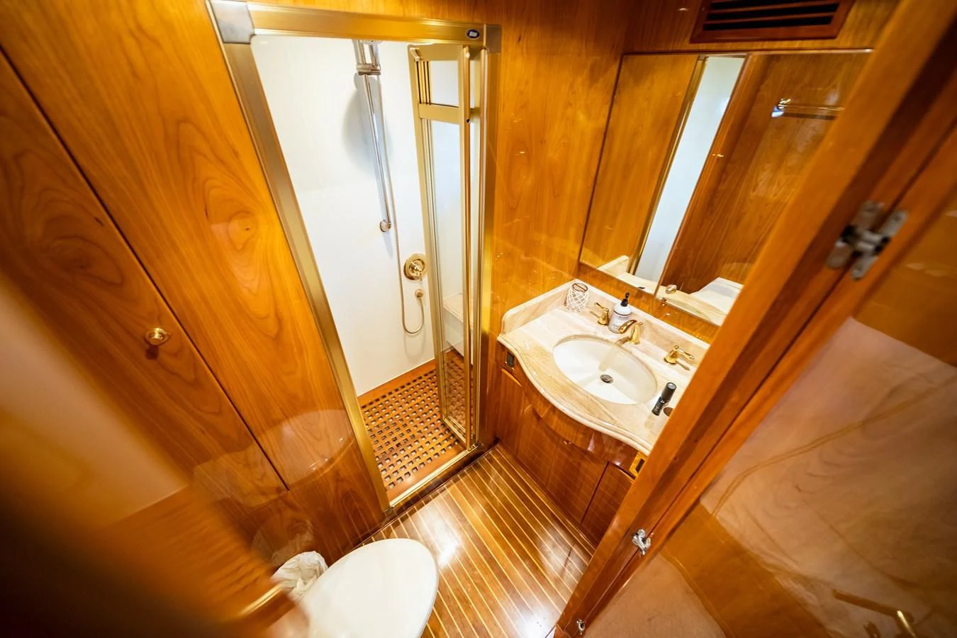a bathroom with a sink and a mirror aboard HAPPY Yacht for Sale