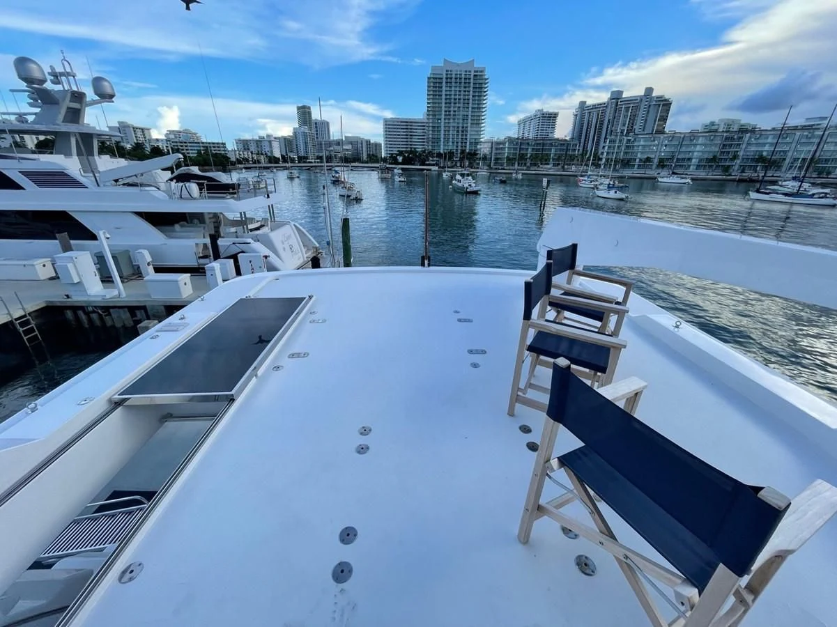 a deck with a view of a city and a body of water aboard HAPPY Yacht for Sale