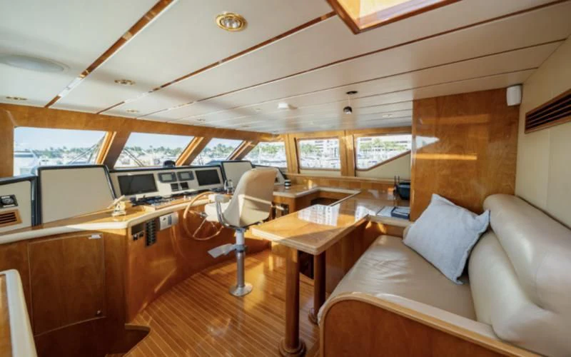 a room with a couch and a table and a chair aboard HAPPY Yacht for Sale