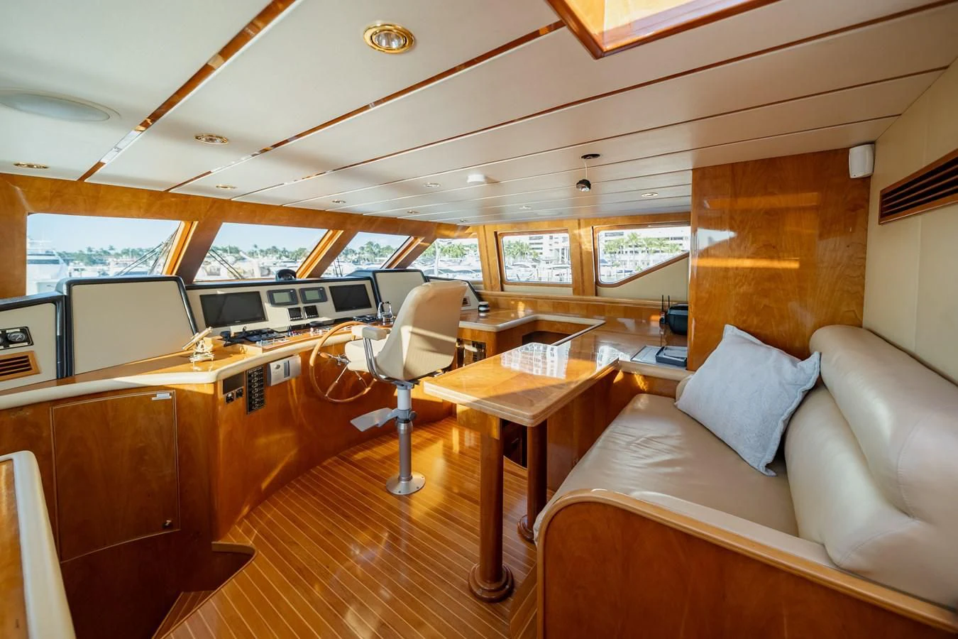 a boat with a couch and a table in it aboard HAPPY Yacht for Sale