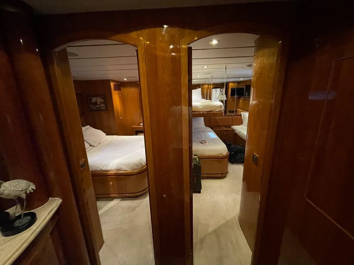 a room with a bed and a mirror aboard HAPPY Yacht for Sale