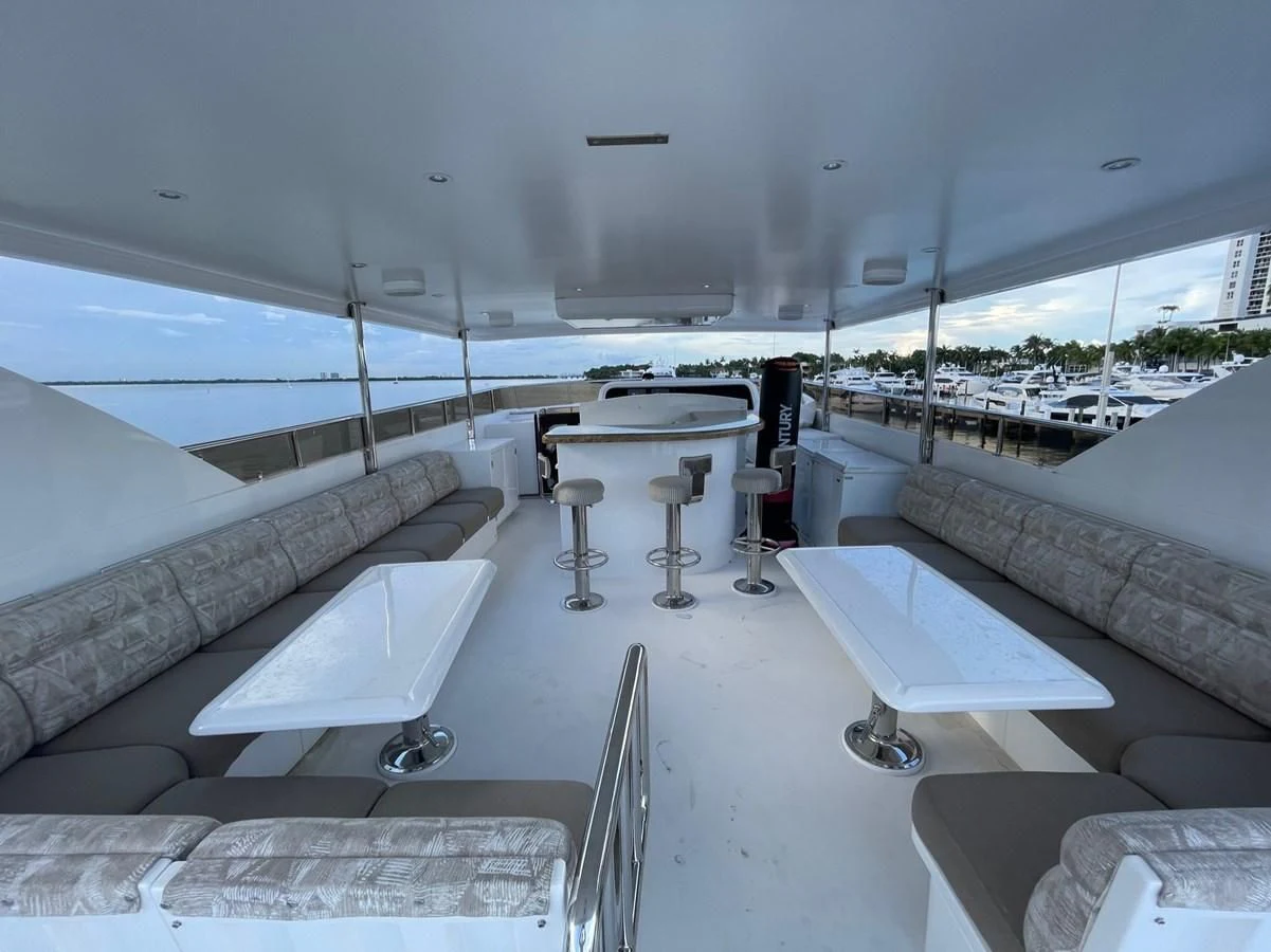 a room with a large white table and chairs and a large window aboard HAPPY Yacht for Sale