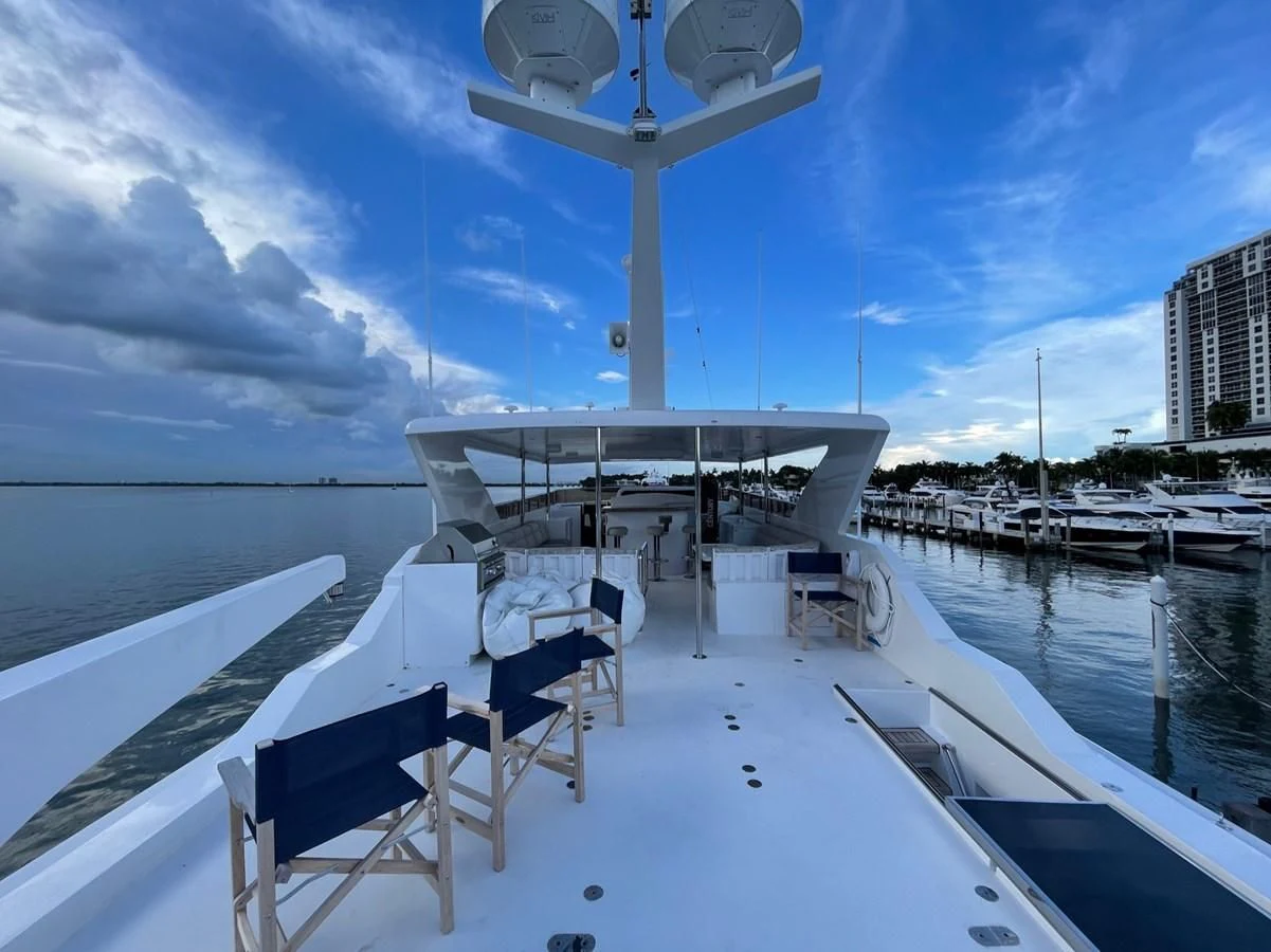 a deck with chairs on it aboard HAPPY Yacht for Sale