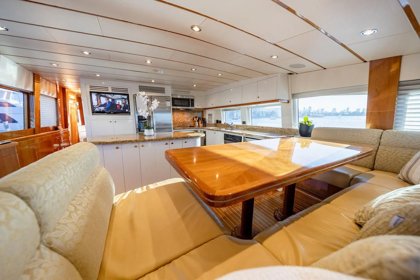 a living room with a table and couches aboard HAPPY Yacht for Sale