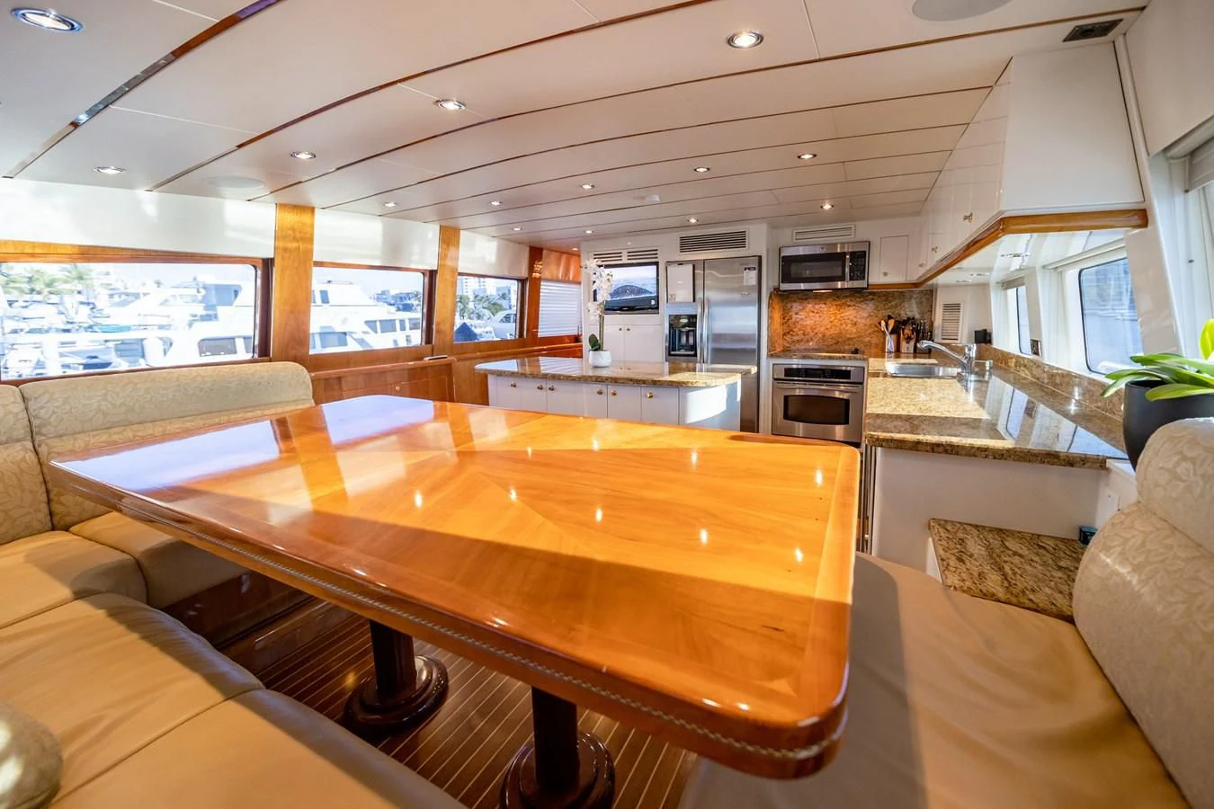 a kitchen with a table and chairs aboard HAPPY Yacht for Sale