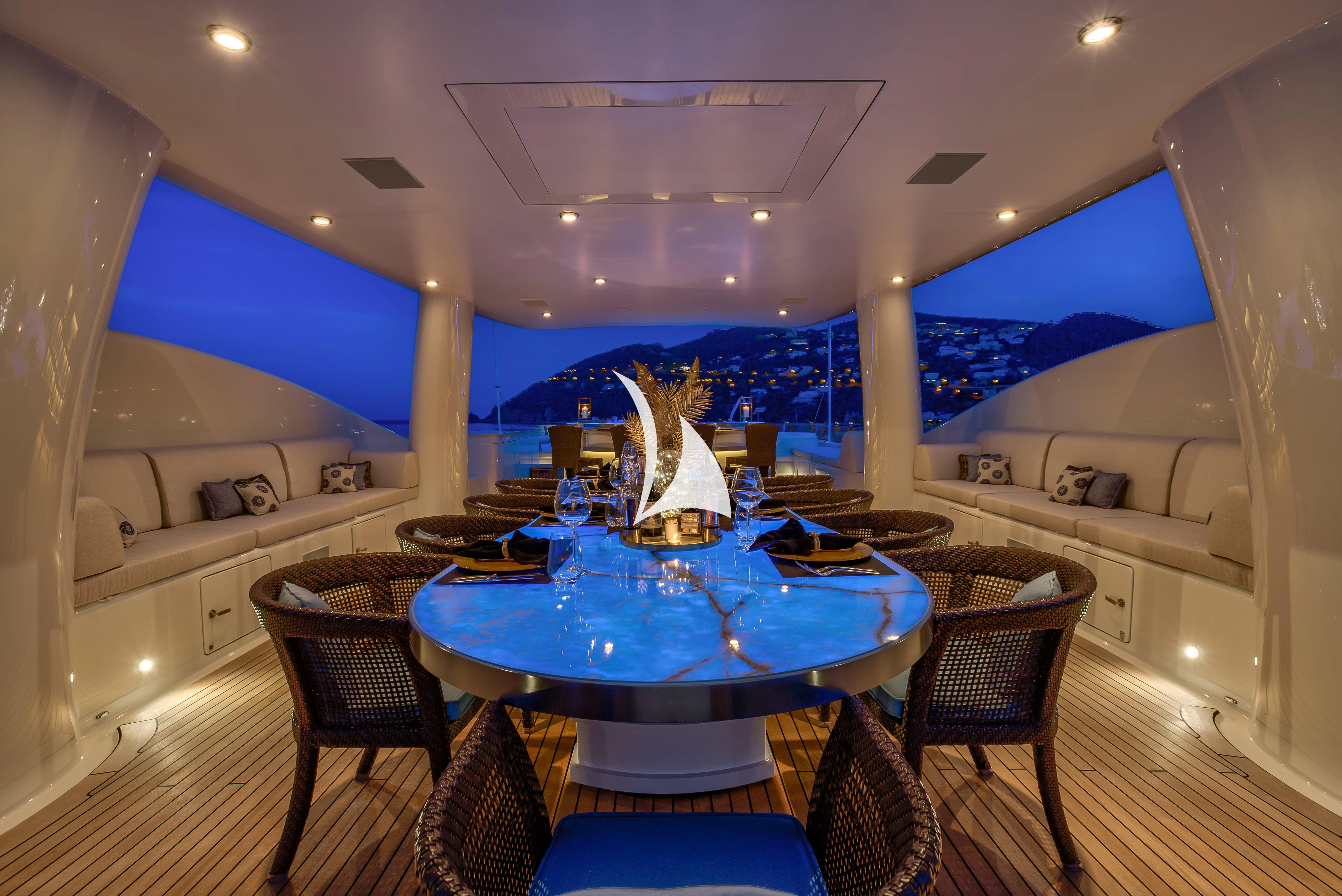 a room with a table and chairs aboard DENIKI Yacht for Sale