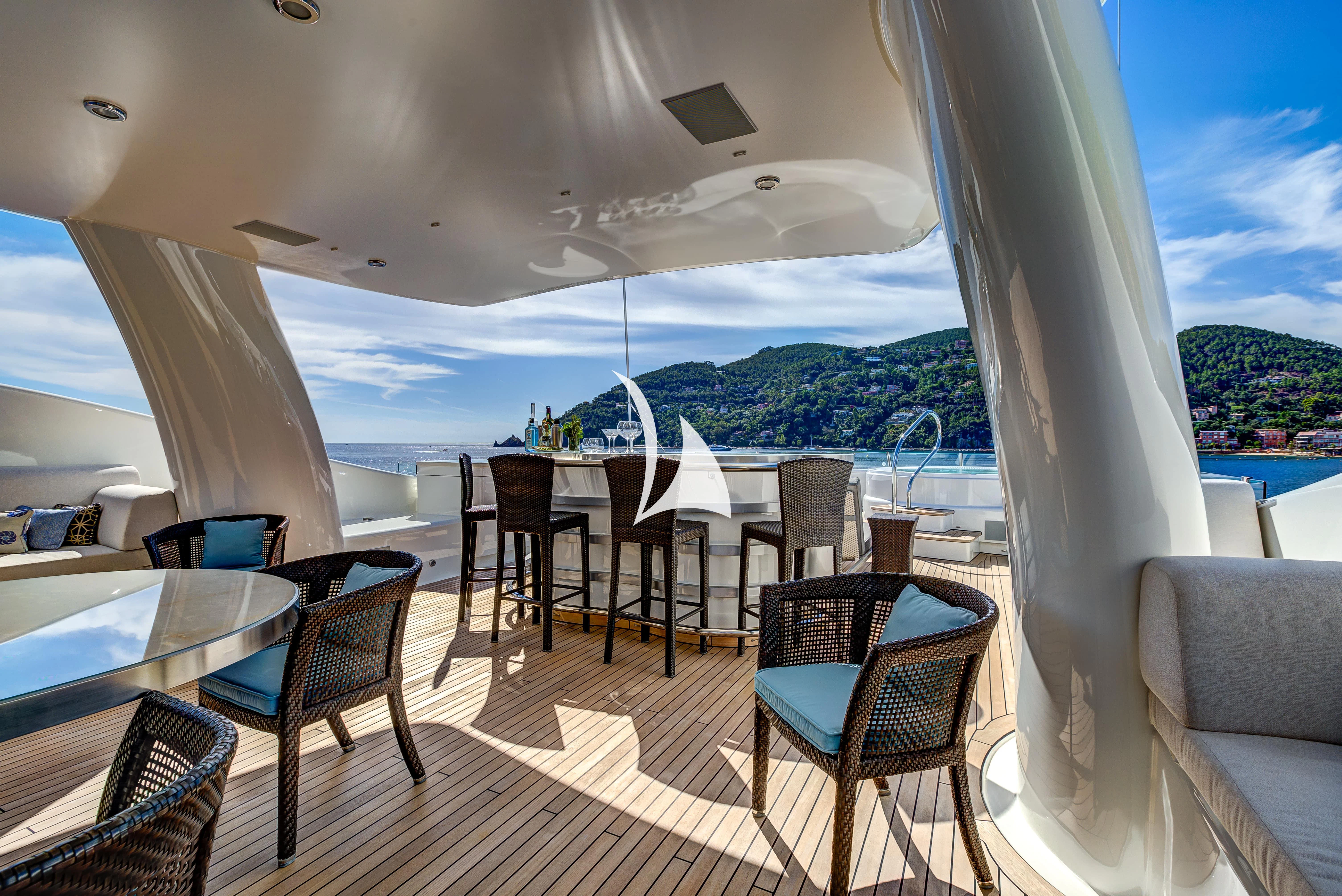 a patio with a table and chairs aboard DENIKI Yacht for Sale