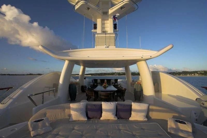 a large space ship with chairs and tables on the deck aboard DENIKI Yacht for Sale
