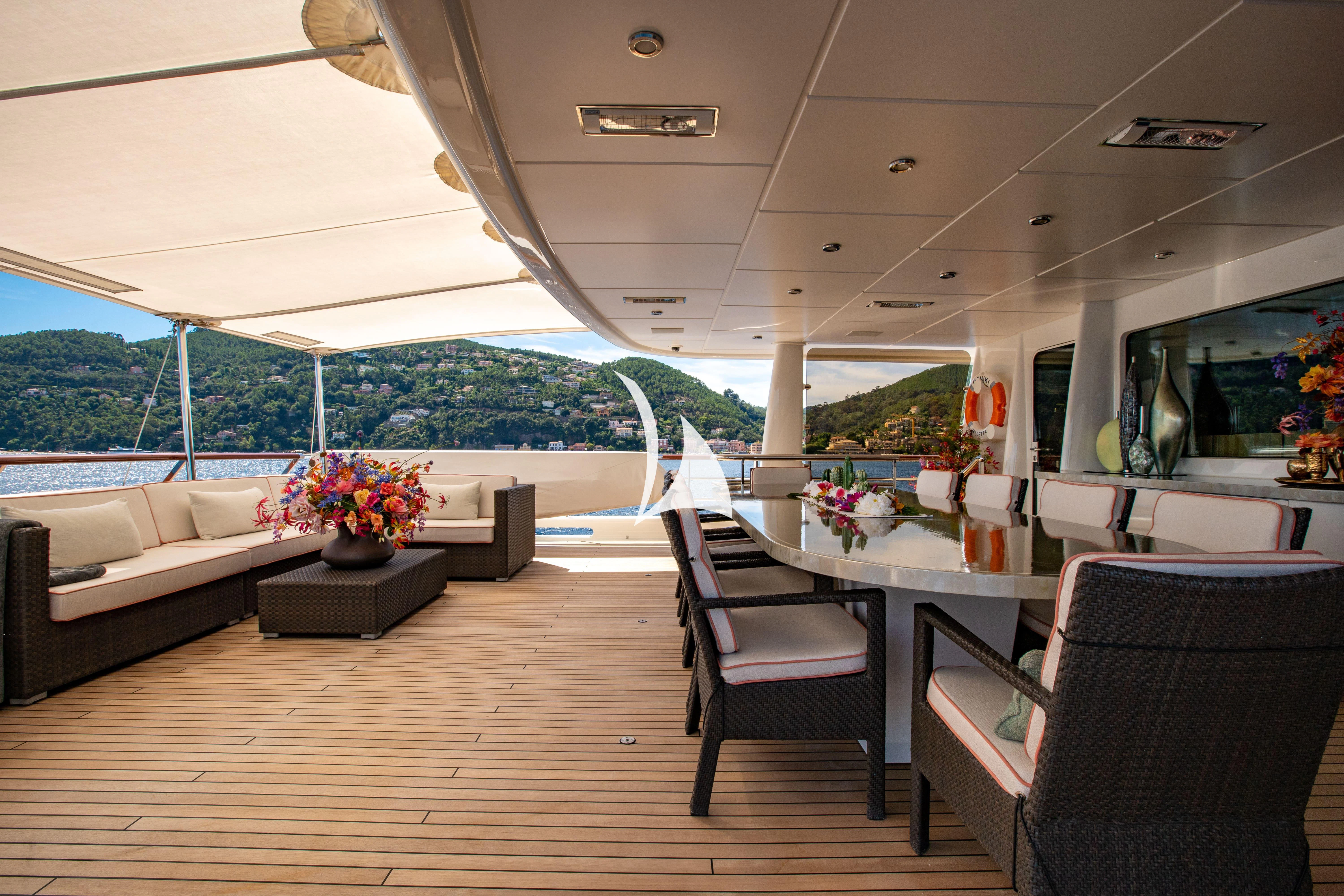 a room with a couch and a table and chairs aboard DENIKI Yacht for Sale