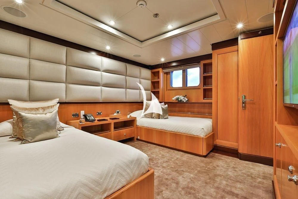 a room with a bed and a desk aboard DENIKI Yacht for Sale