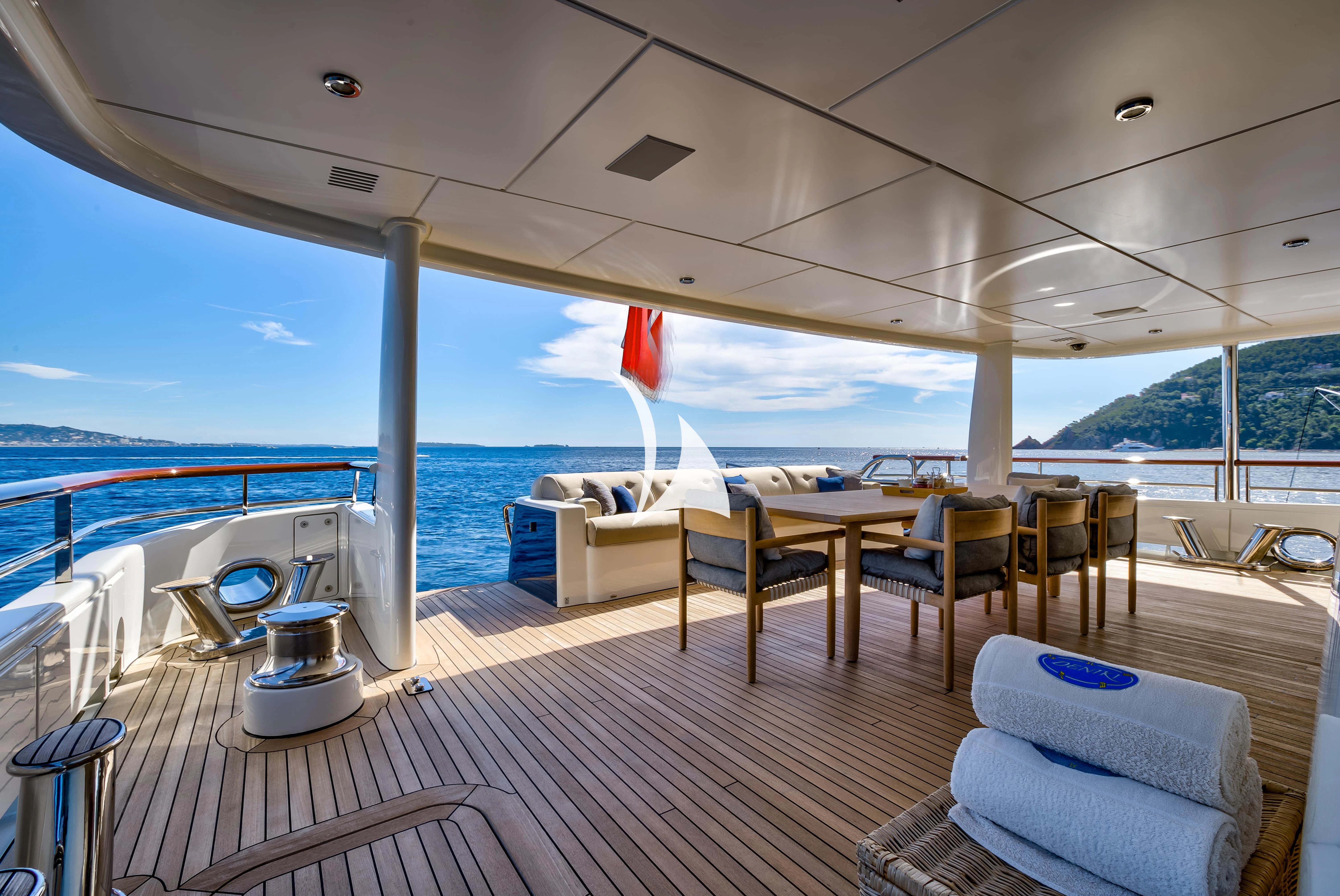 a deck with a large deck and chairs and a large body of water aboard DENIKI Yacht for Sale