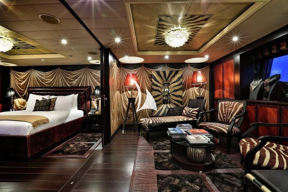 a hotel room with a bed and a table aboard DENIKI Yacht for Sale