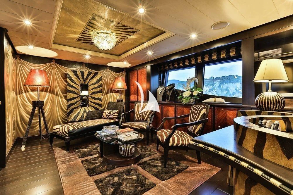 a living room with a large screen aboard DENIKI Yacht for Sale
