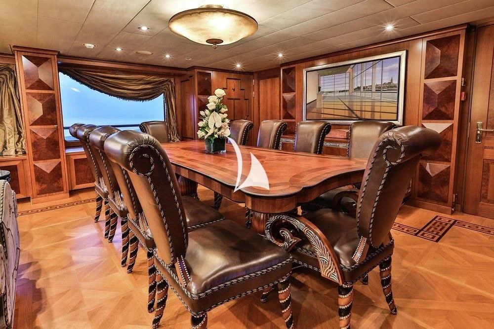 a dining table in a room aboard DENIKI Yacht for Sale