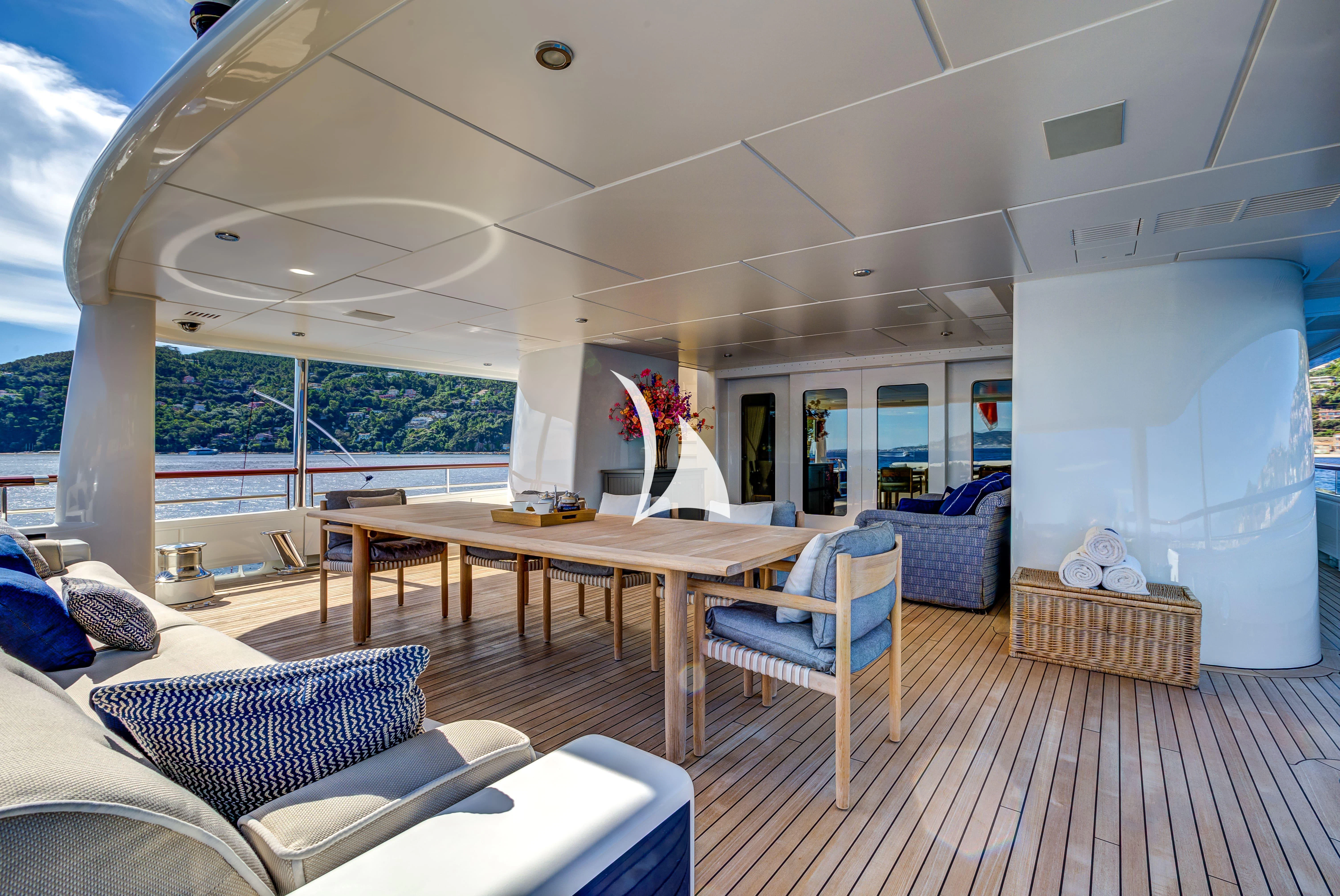 a living room with a table and chairs aboard DENIKI Yacht for Sale