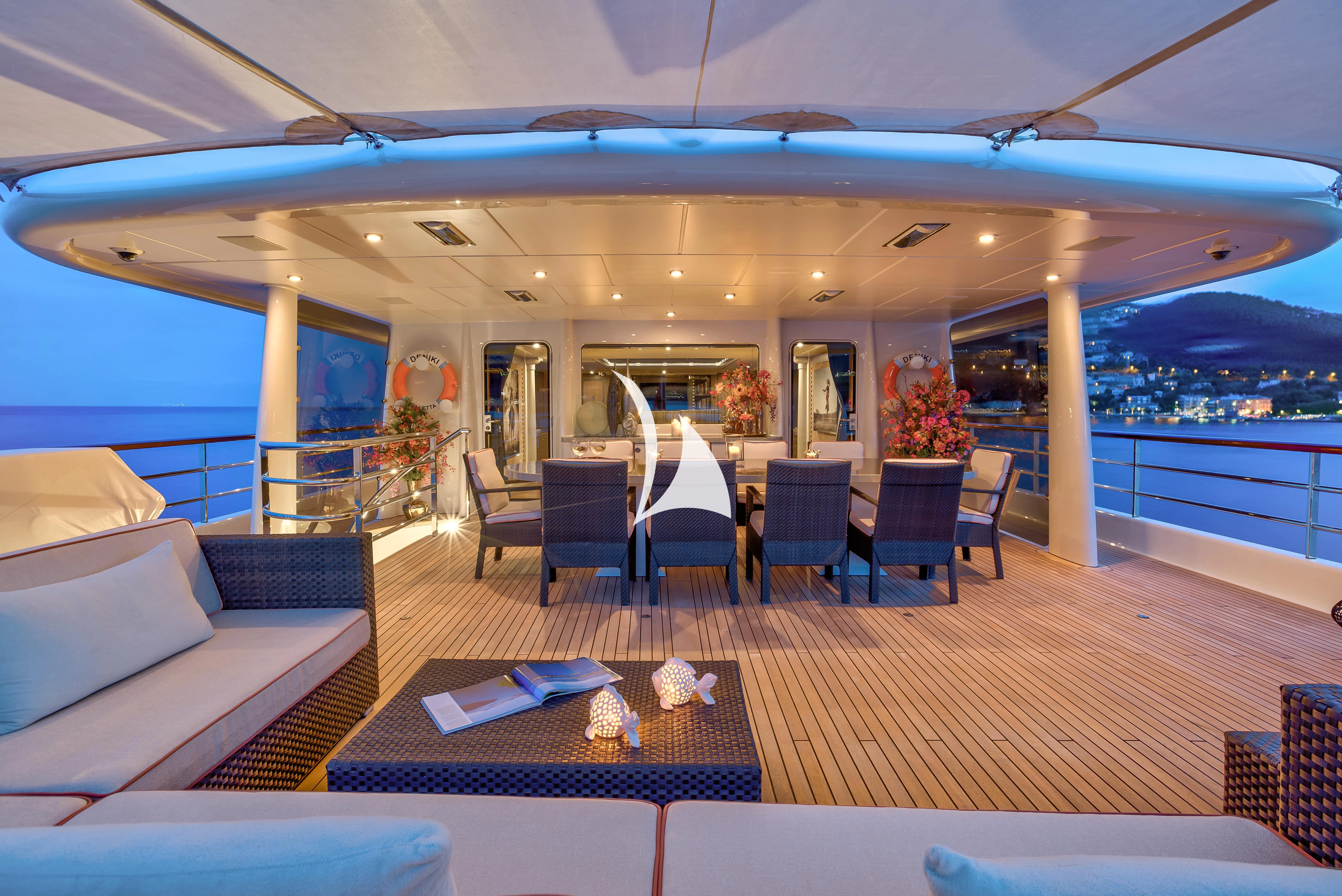 a room with a table and chairs aboard DENIKI Yacht for Sale