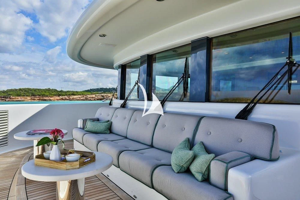 a boat with pillows and a table aboard DENIKI Yacht for Sale