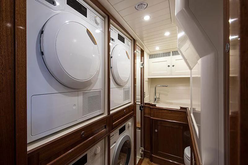 a white washing machine in a kitchen aboard VIJONARA Yacht for Sale